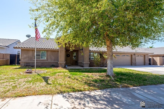 6257 E 47th St, Yuma, AZ 85365 - view of front of home with a garage, driveway, stucco siding, and a tiled roof