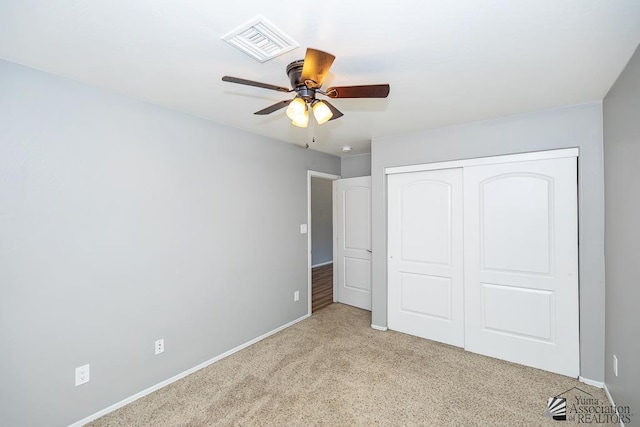 6257 E 47th St, Yuma, AZ 85365 - unfurnished bedroom featuring light colored carpet, a closet, and a ceiling fan