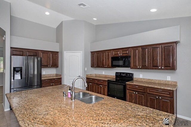 6257 E 47th St, Yuma, AZ 85365 - kitchen with black appliances, dark brown cabinetry, high vaulted ceiling, recessed lighting, and light stone counters