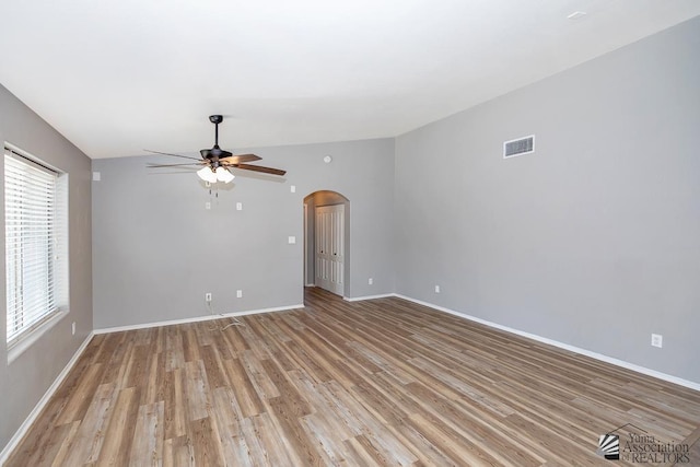 6257 E 47th St, Yuma, AZ 85365 - unfurnished room featuring a ceiling fan, arched walkways, and light wood-type flooring