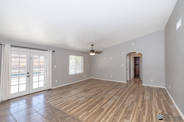 6257 E 47th St, Yuma, AZ 85365 - empty room with ceiling fan, arched walkways, french doors, and light wood-style flooring