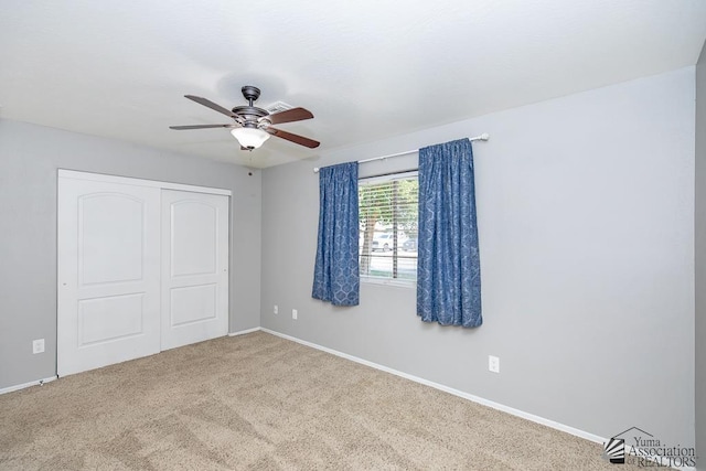 6257 E 47th St, Yuma, AZ 85365 - unfurnished bedroom with a closet, carpet, and a ceiling fan