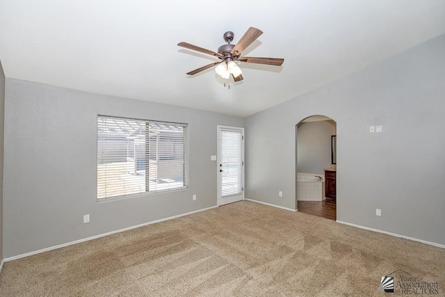 6257 E 47th St, Yuma, AZ 85365 - carpeted empty room with arched walkways and a ceiling fan