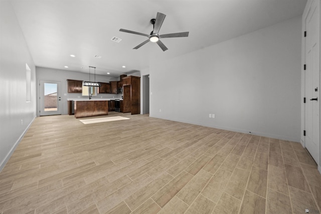 10770 E 45th Ln, Yuma, AZ 85367 - unfurnished living room with light wood-type flooring, a ceiling fan, and recessed lighting
