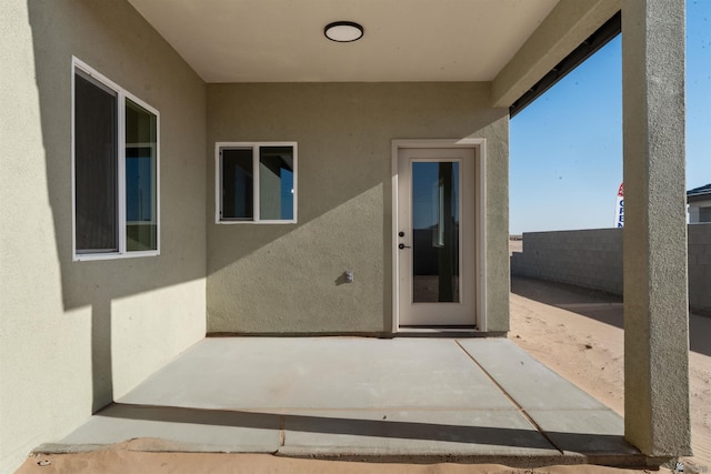 10770 E 45th Ln, Yuma, AZ 85367 - view of exterior entry with a patio and stucco siding