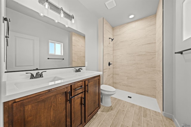10770 E 45th Ln, Yuma, AZ 85367 - bathroom featuring tiled shower, double vanity, wood finish floors, and recessed lighting