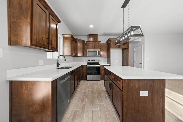 10770 E 45th Ln, Yuma, AZ 85367 - kitchen with stainless steel appliances, light wood-style flooring, a kitchen island, light countertops, and recessed lighting