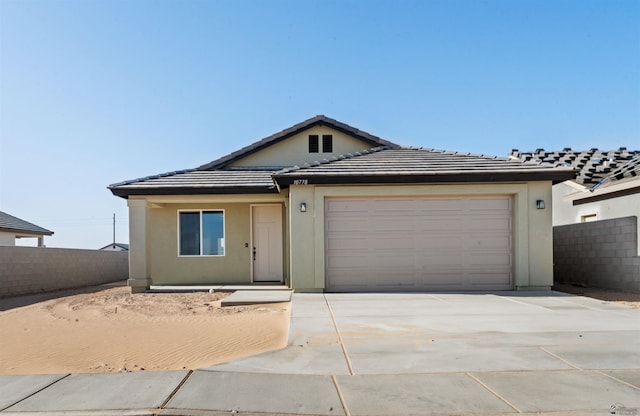 10770 E 45th Ln, Yuma, AZ 85367 - view of front of house featuring driveway, an attached garage, stucco siding, and a tiled roof