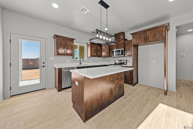 10770 E 45th Ln, Yuma, AZ 85367 - kitchen featuring appliances with stainless steel finishes, a center island, recessed lighting, light wood finished floors, and light countertops