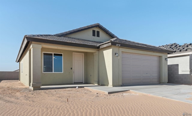 10770 E 45th Ln, Yuma, AZ 85367 - view of front of property featuring a garage, driveway, a tiled roof, and stucco siding