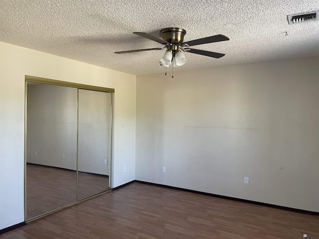 1603 S 31st Dr, Yuma, AZ 85364 - unfurnished bedroom with wood finished floors, a closet, a textured ceiling, and a ceiling fan