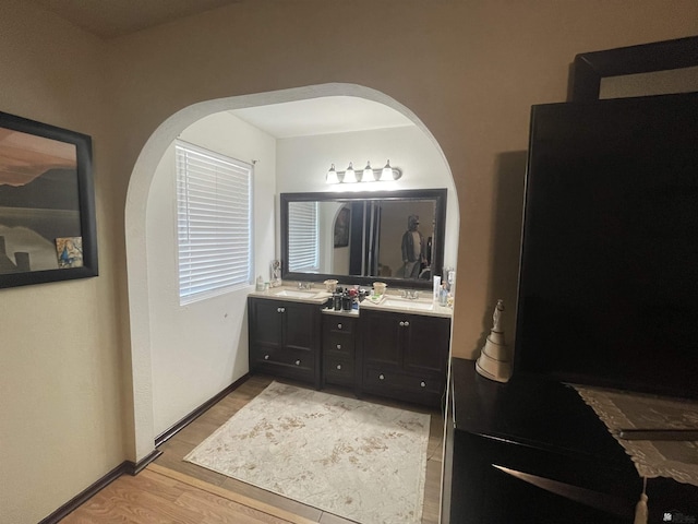 1603 S 31st Dr, Yuma, AZ 85364 - bathroom with double vanity, baseboards, a sink, and wood finished floors