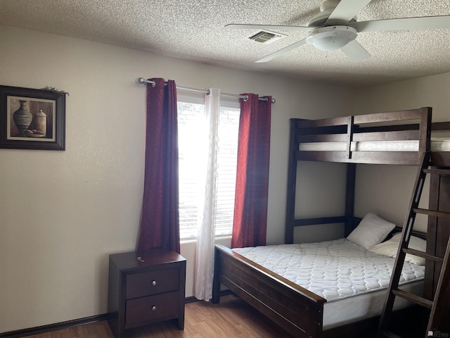 1603 S 31st Dr, Yuma, AZ 85364 - bedroom with a textured ceiling, wood finished floors, and a ceiling fan