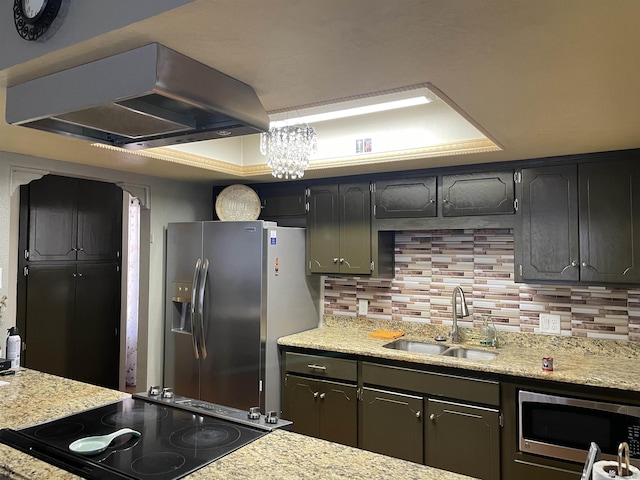 1603 S 31st Dr, Yuma, AZ 85364 - kitchen with appliances with stainless steel finishes, island range hood, backsplash, a tray ceiling, and light stone counters