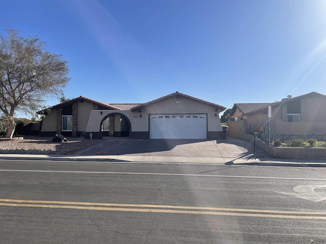 1603 S 31st Dr, Yuma, AZ 85364 - single story home with an attached garage, driveway, a tile roof, and stucco siding