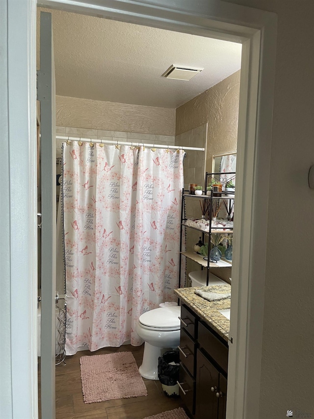 1603 S 31st Dr, Yuma, AZ 85364 - bathroom featuring a textured wall, vanity, wood finished floors, a shower with shower curtain, and a textured ceiling