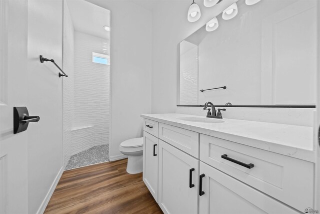 5922 E 47th St, Yuma, AZ 85365 - bathroom featuring a tile shower, vanity, and wood finished floors