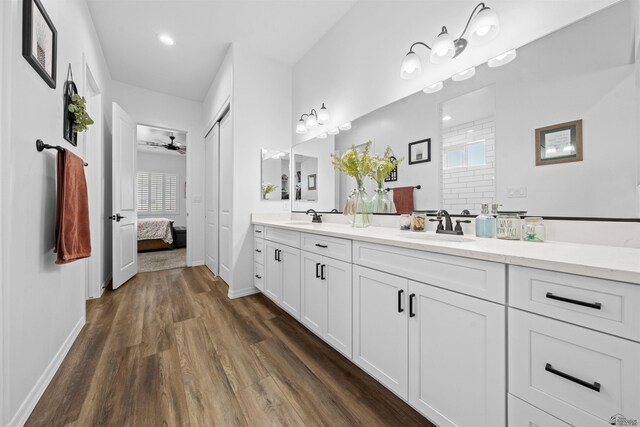 5922 E 47th St, Yuma, AZ 85365 - bathroom with wood finished floors, double vanity, ensuite bathroom, a ceiling fan, and a tile shower