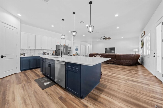 5922 E 47th St, Yuma, AZ 85365 - kitchen with stainless steel appliances, light wood finished floors, open floor plan, ceiling fan, and light countertops
