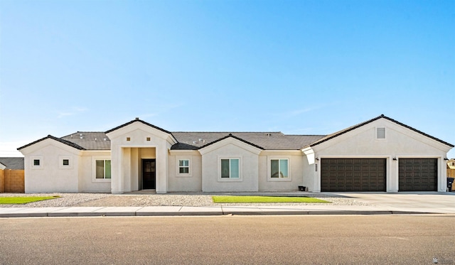 5922 E 47th St, Yuma, AZ 85365 - view of front facade with a garage, driveway, and stucco siding