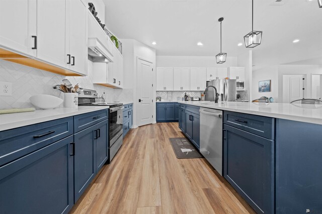 5922 E 47th St, Yuma, AZ 85365 - kitchen with appliances with stainless steel finishes, blue cabinets, light wood-style floors, white cabinets, and light countertops