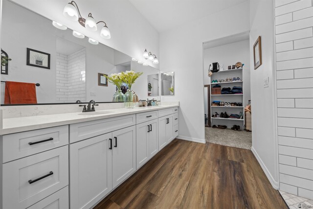 5922 E 47th St, Yuma, AZ 85365 - bathroom featuring double vanity, wood finished floors, and a spacious closet