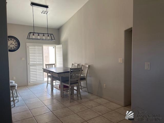 dining room with tile patterned floors and visible vents