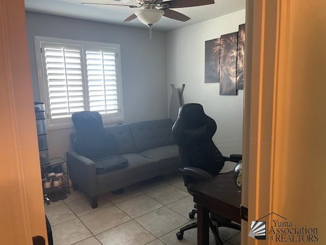 office space featuring a ceiling fan and light tile patterned flooring