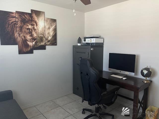 office with baseboards, a ceiling fan, and light tile patterned flooring