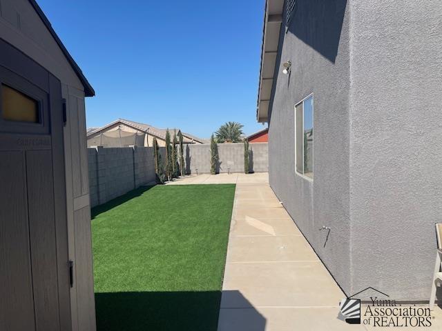 view of yard with a patio and a fenced backyard