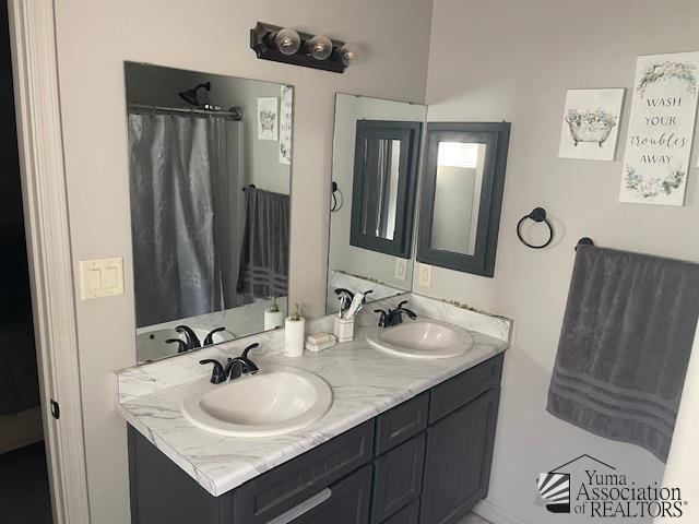 bathroom featuring double vanity and a sink