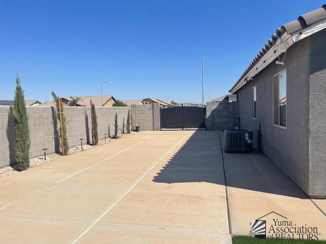 exterior space with central air condition unit and fence