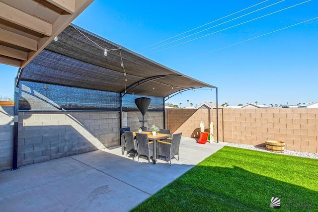 view of patio featuring a fenced backyard and outdoor dining space