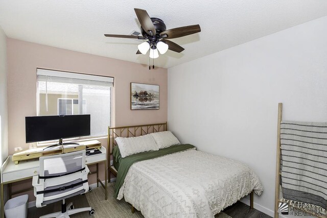 bedroom featuring baseboards, ceiling fan, and wood finished floors