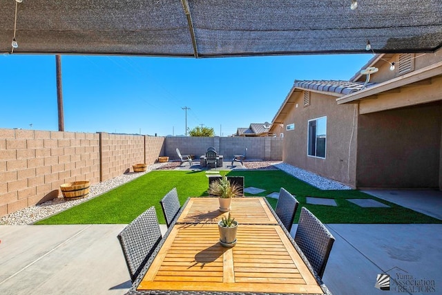 view of patio with a fenced backyard and outdoor dining area