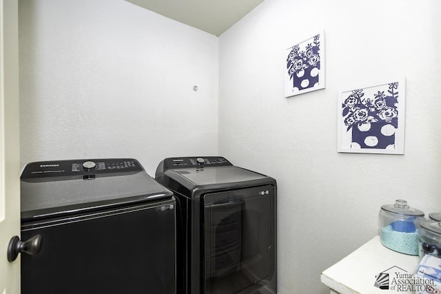 washroom with separate washer and dryer and laundry area