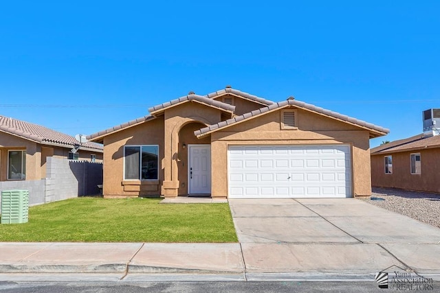 view of front of home with fence, an attached garage, a front lawn, stucco siding, and concrete driveway