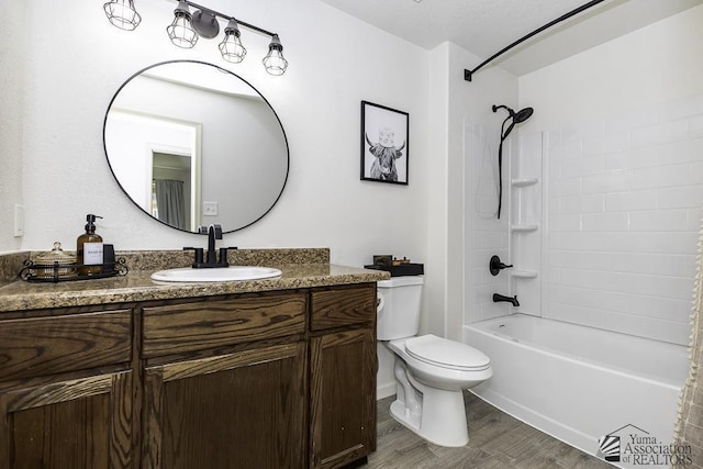 full bathroom featuring toilet, wood finished floors, shower / bathing tub combination, and vanity