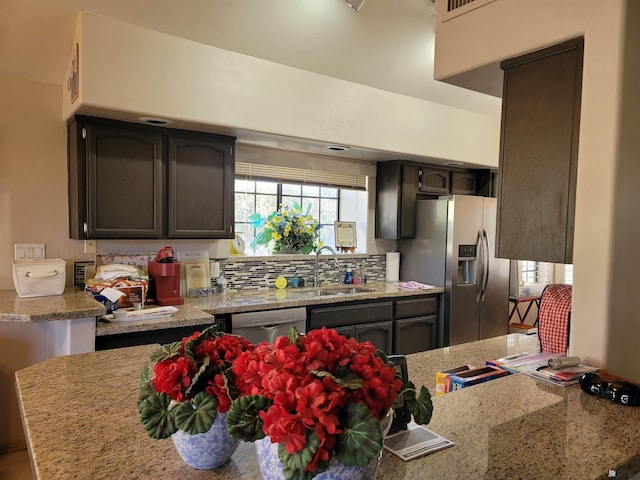 10842 S Via Salida, Yuma, AZ 85367 - kitchen featuring light stone counters, a sink, backsplash, and stainless steel appliances