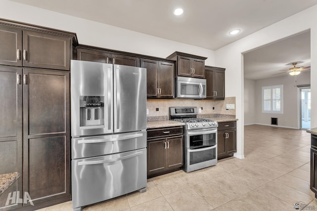 kitchen with dark brown cabinetry, tasteful backsplash, a ceiling fan, appliances with stainless steel finishes, and light tile patterned floors