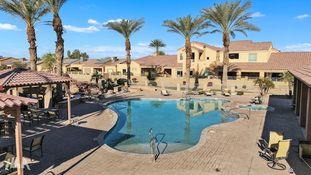 pool featuring a residential view, fence, a gazebo, and a patio area