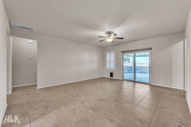empty room with visible vents, baseboards, ceiling fan, and light tile patterned flooring