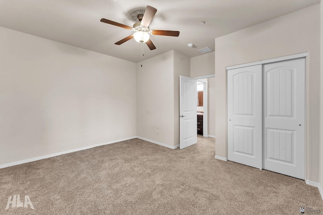 unfurnished bedroom with visible vents, a closet, baseboards, light colored carpet, and a ceiling fan