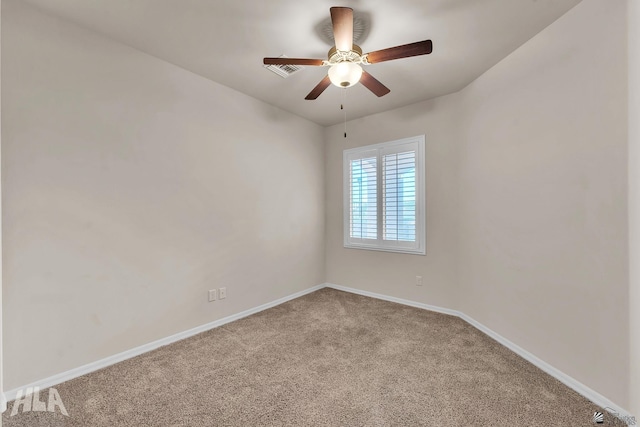 carpeted empty room with baseboards, a ceiling fan, and visible vents