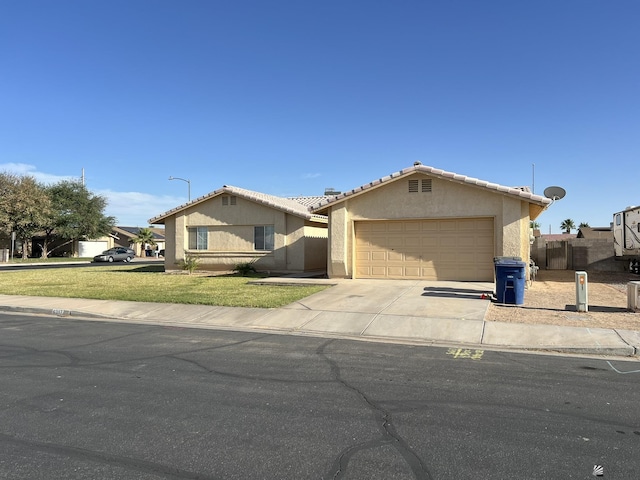 6397 E 42nd St, Yuma, AZ 85365 - single story home featuring stucco siding, a garage, concrete driveway, and a tile roof