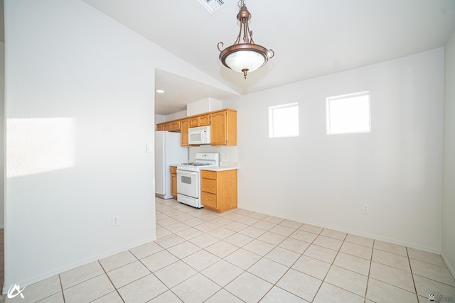 interior space with baseboards, lofted ceiling, light tile patterned flooring, and visible vents