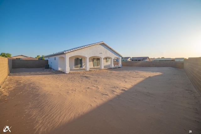 view of front of house with a fenced backyard and stucco siding