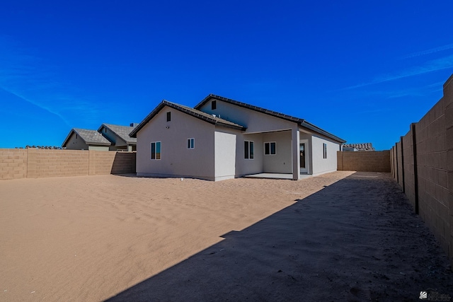 10778 E 45th Ln, Yuma, AZ 85367 - back of property with a patio, a fenced backyard, and stucco siding