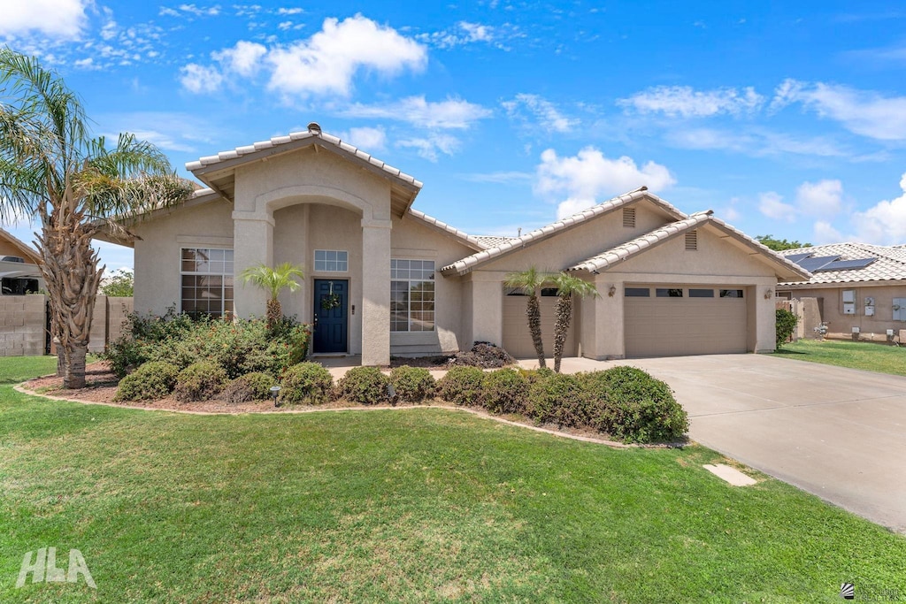 3636 W 26th St, Yuma, AZ 85364 - mediterranean / spanish home with driveway, stucco siding, an attached garage, and a tiled roof