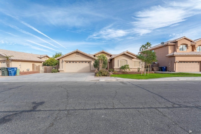 1653 S 42nd Ave, Yuma, AZ 85364 - view of front of house featuring stucco siding, concrete driveway, an attached garage, and a tile roof